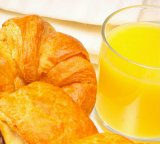 croissant and glass of orange juice for breakfast: croissant, plate, white, golden, french, france, food, cuisine, continental, breakfast, eat, hungry, hunger, kitchen, chef, bake, cook, morning, pastry, pastries
