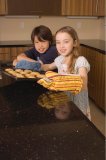 Portrait of Asian boy and Caucasian girl with cookies
