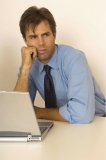Portrait of a business man using a laptop computer.