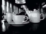 teapot and cups on table: monochrome black and white contemporary cafe break time drink beverage tea coffee relax leisure shopping modern windows