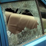 Broken car window, result of car crime.