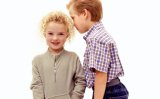 A young girl and young boy share secrets.