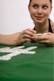 Upclose portrait of woman playing a game of dominoes.