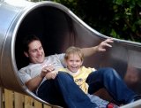 Father and son enjoy the fun of a slide
