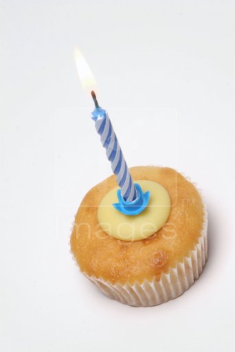 Cup cake with blue candle in it
