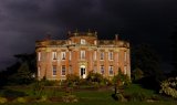 Chettle House, Chettle, Blandford Forum, Dorset, England, UK. View of front of house with dramatic lighting.
