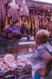 La Boqueria market - also known as St Josep, Las Ramblas, Barcelona, Catalan,Spain,EU: view of shop worker smoking at food counter.
