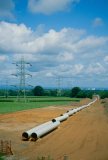 UK, water or gas service pipes and electricity cables across landscape