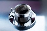Stainless steel cup of black coffee