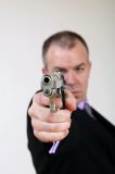 Man in suit with gun