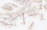 Pile of transparent plastic map pins on white background