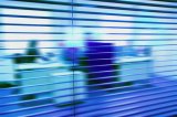 blurred office workers through venetian blind: office workplace employee staff busy business blind slats