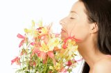 Young woman smelling flowers