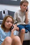 Portrait of two young kids worried on the telephone.