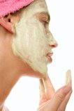 Woman appyling face mask