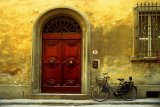 "Black Bicycle": a black bicycle leans against the wall in the leather district of Florence