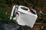Washing machine dumped in woods.
