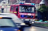 Fire Engine attending incident in busy suburban UK street.