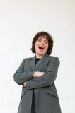 Business woman in gray suit laughing