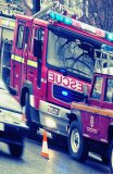 Fire Engine attending incident in busy suburban UK street.