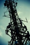 A telecommunications mast against a blue sky