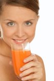 Young woman drinking carrot juice