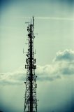 A telecommunications mast against a sky background