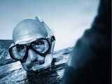 Black and white image of a man snorkelling in the sea