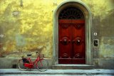 "Red Bicycle 2": a red bicycle leans against a golden wall in the old city of Florence